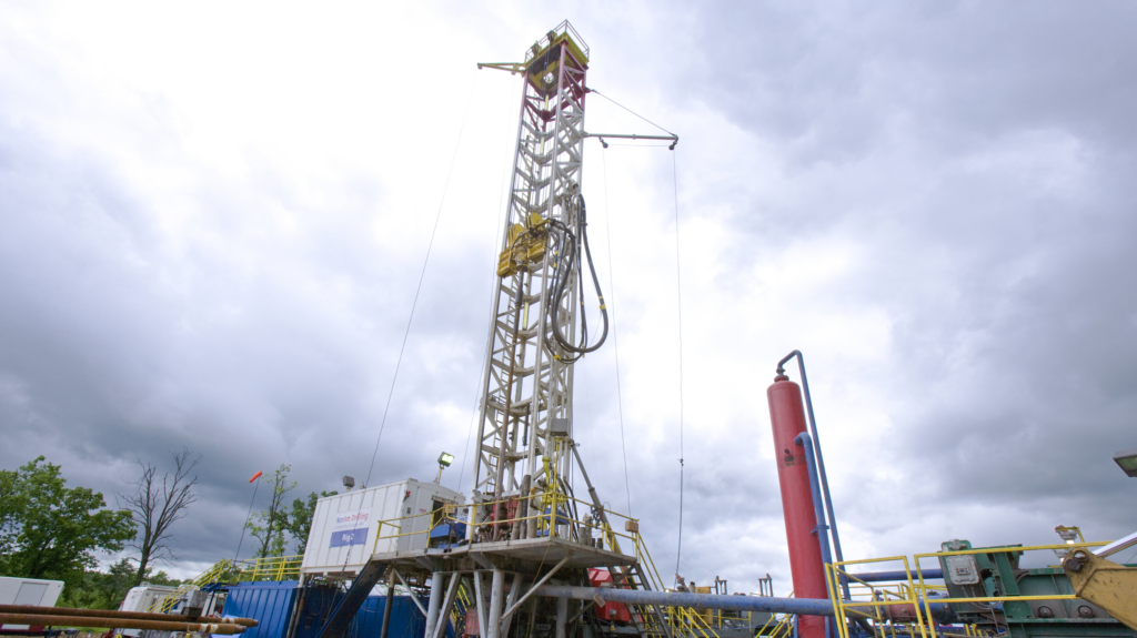 Dark clouds loom behind a drill rig.
