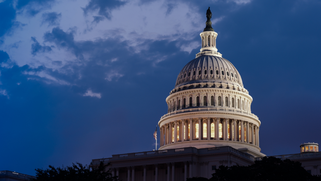 The U.S. Capitol illuminated before an ominous night sky.